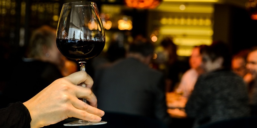Cheers with wine in a cosy Thimphu lounge bar, Bhutan perfect for a relaxed evening.