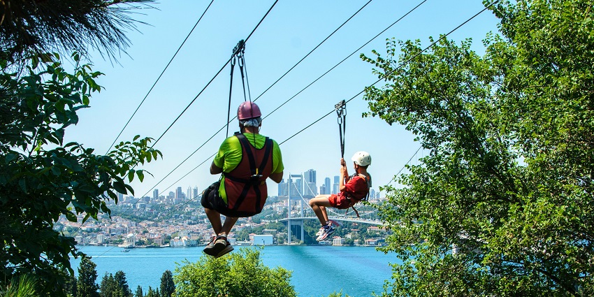 Zip liner soaring over lush landscapes with views experiencing adventure sports in Nepal.