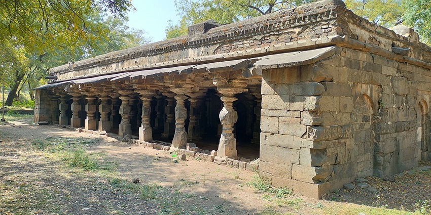 A picture of a historical structure built at the Bhuikot Fort, surrounded by a forest area
