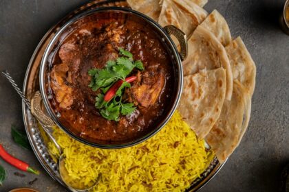 A vibrant bowl of curry rice served with warm pita bread -best food in Chandni Chowk