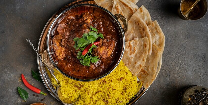 A vibrant bowl of curry rice served with warm pita bread -best food in Chandni Chowk