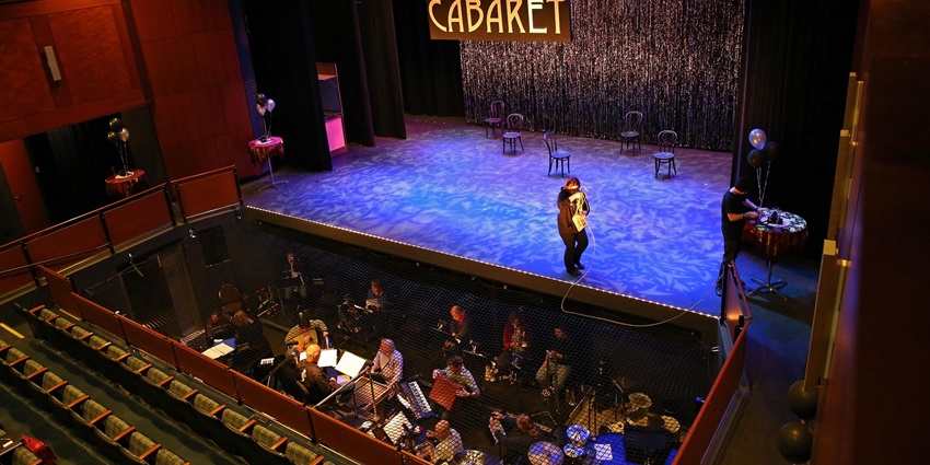 A glimpse of people attending the famous Alcazar Cabaret Show inside a splendid theatre.