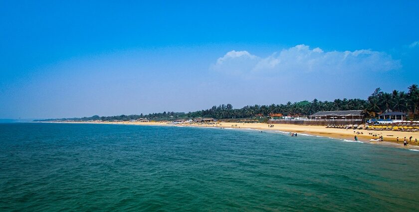 An enchanting vista of cobalt blue waters touching the golden sands filled with people.