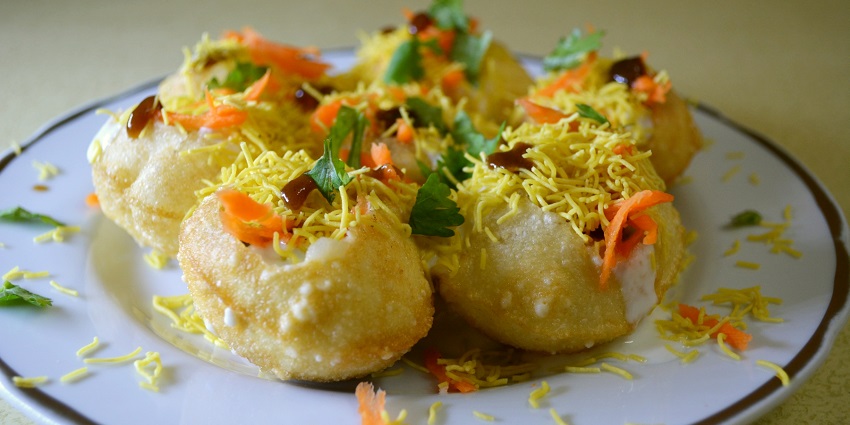 Dahi puri, served with mint and sweet chutney sprinkled with sev, one of the best snacks of the city