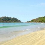 A picture of a Beach in Goa with pristine waters approaching the shore