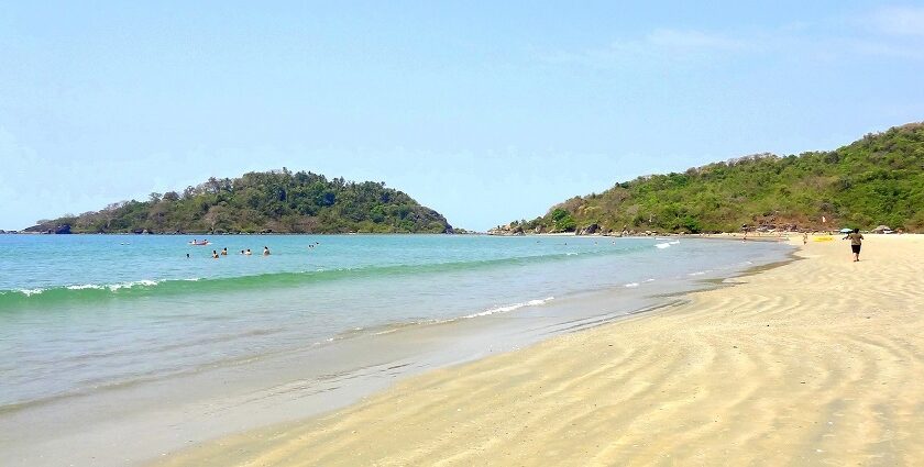 A picture of a Beach in Goa with pristine waters approaching the shore