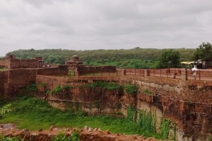 A view of the Ranthambore Fort, perched on a hilltop and surrounded by dense greenery.