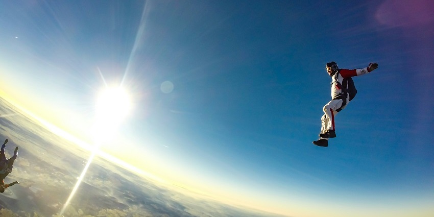 A man is suspended in air in iFly Dubai, one of the top spots for indoor skydiving Dubai.