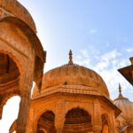 Image of Jaisalmer - explore the War Museum features a red archway, military decorations