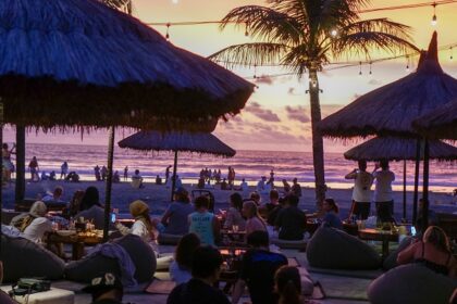 View of a vibrant beachside restaurant at sunset, offering into a glimpse of night life in north Goa