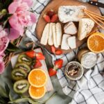 Image of picnic basket and food on the sheet in a garden - picnic places near Ahmedabad