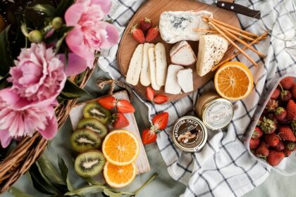 Image of picnic basket and food on the sheet in a garden - picnic places near Ahmedabad