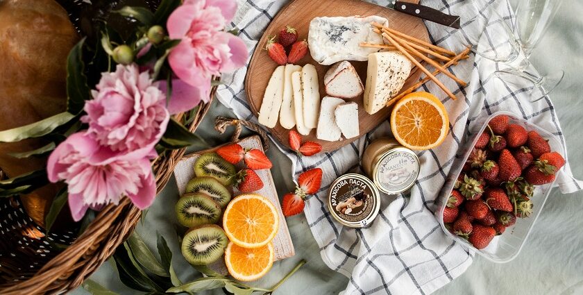 Image of picnic basket and food on the sheet in a garden - picnic places near Ahmedabad