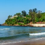 Image of Beautiful Baga beach with waves lapping up onto the shore in a perfect sunny day