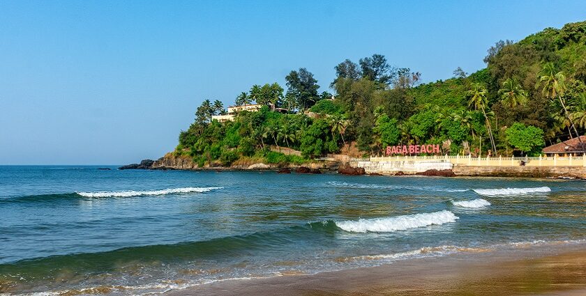 Image of Beautiful Baga beach with waves lapping up onto the shore in a perfect sunny day