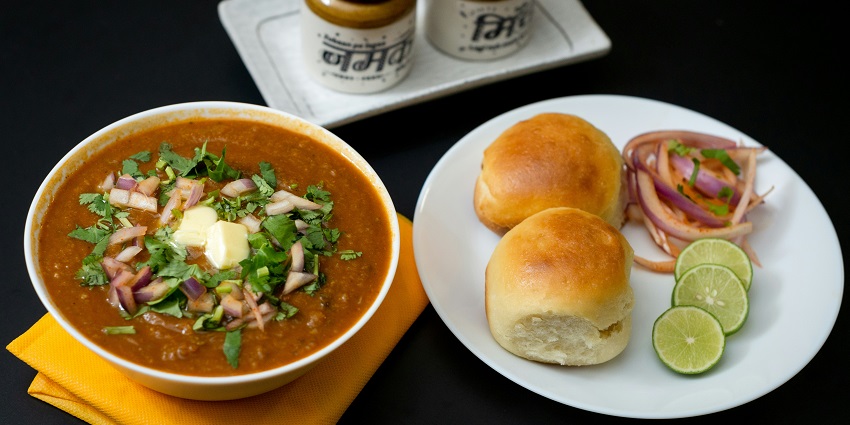 Pav Bhaji served with chopped onion and lemon, one of the top street foods in Dwarka.