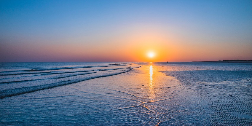People enjoying sunset at Mandvi Beach.