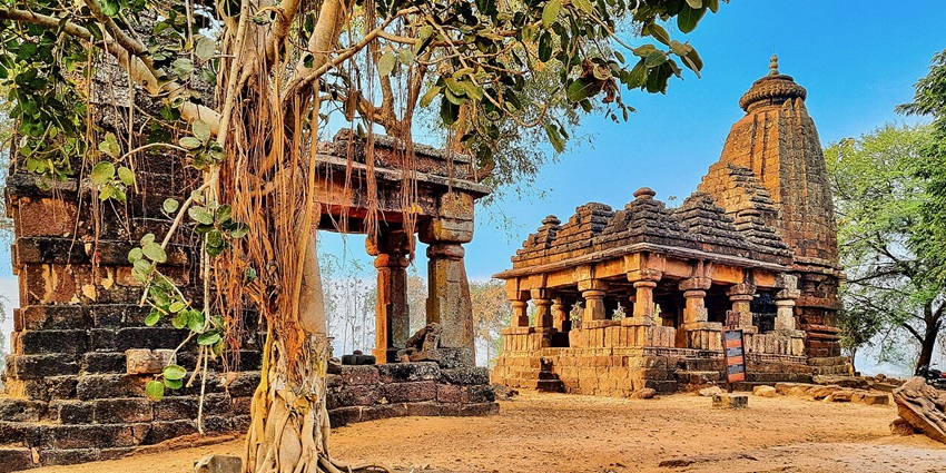 Ancient stone Shiva temple under a tree in Maharashtra
