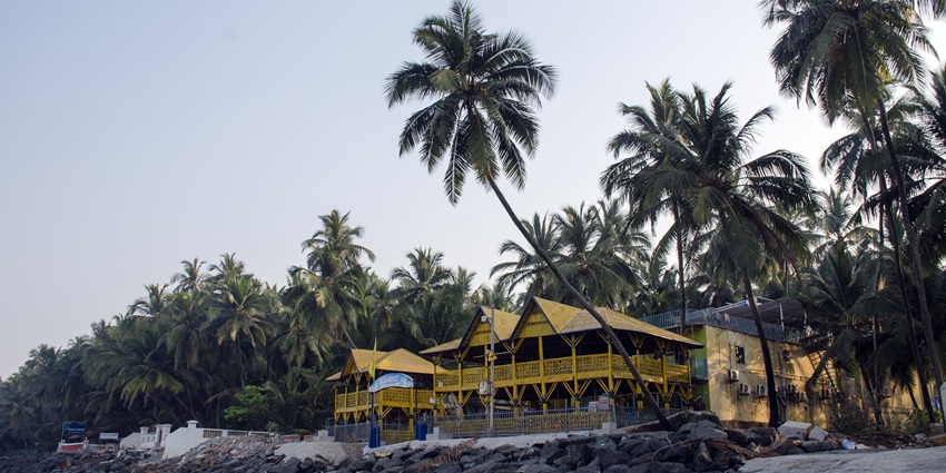 Gorai Beach Resort with palm trees, sandy pathways, and a relaxed coastal atmosphere.