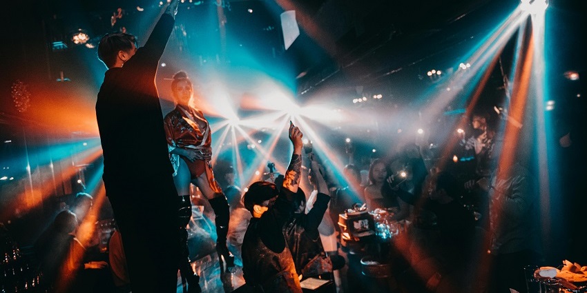An image of a rave party in Bangkok in an old factory with industrial vibes.