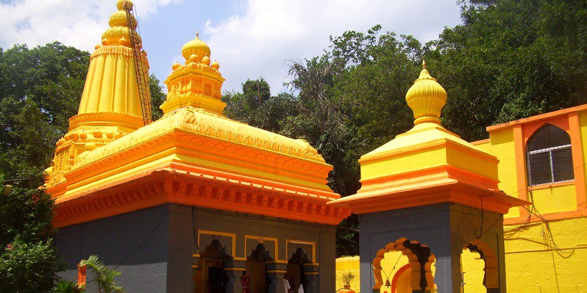 View of the vibrant Baneshwar temple against the clear blue sky