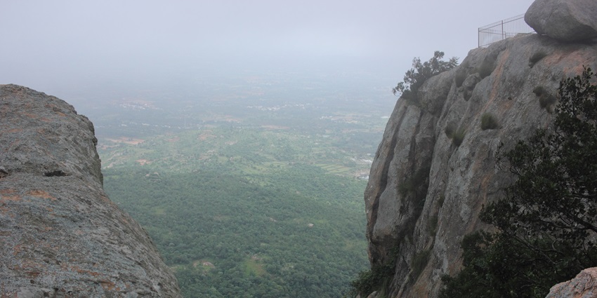 A picture of a rocky hill top offering views of lush valleys in the background