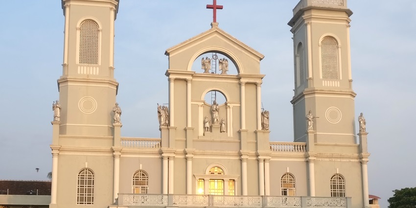 Admire the exterior view of Milagres Church in Mangalore with white facade and central bell tower.