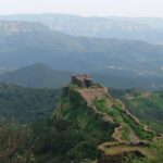 A picture of Mahabaleshwar’s Pratapgad Fort surrounded by lush green hills.