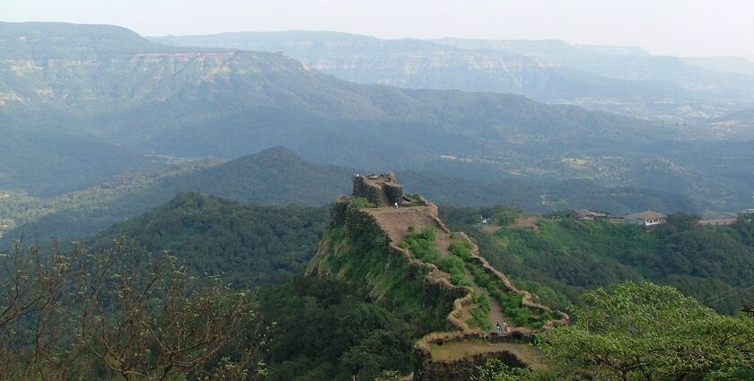 A picture of Mahabaleshwar’s Pratapgad Fort surrounded by lush green hills.