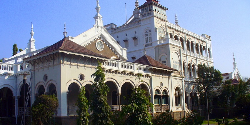 A view of an elegant palace, rich history, serene gardens, tribute to Gandhi's legacy.