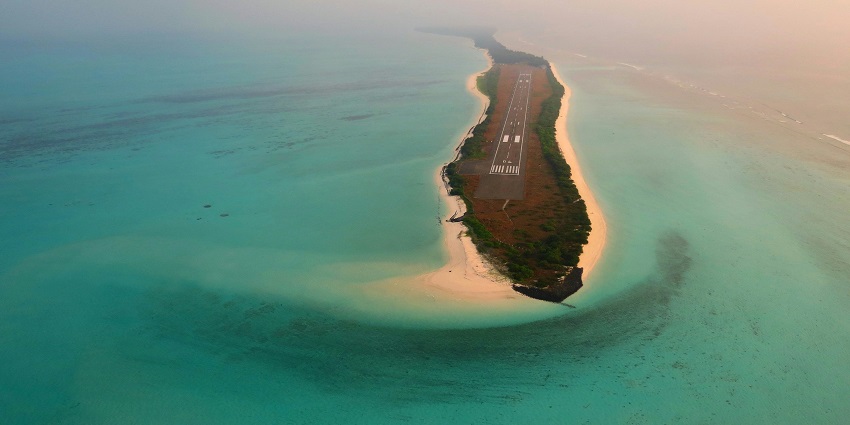An aerial view of the serene Agatti Island, surrounded by turquoise-blue waters.
