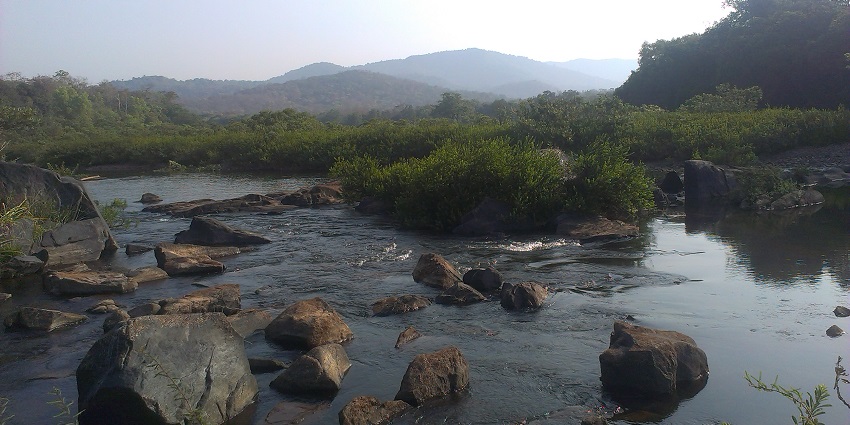 Aghanashini River's scenic beauty with lush greenery, rocky landscapes, and serene reflections.