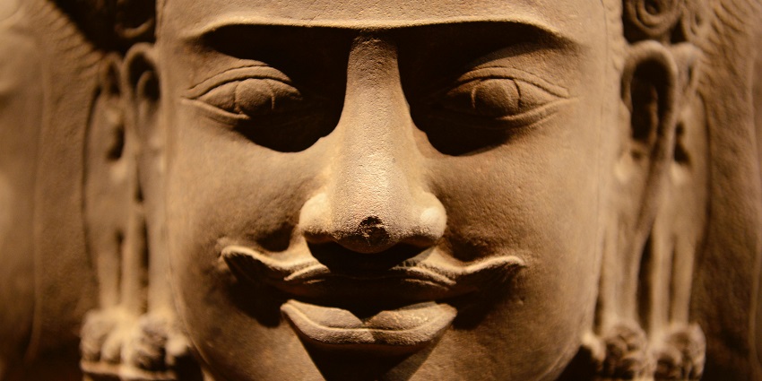 Intricate details of an ancient sculpture showcasing historical artistry.