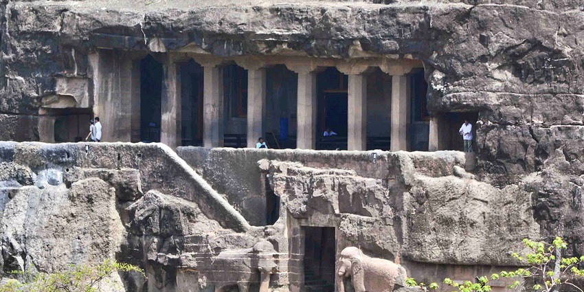 Ancient rock-cut caves showcasing intricate sculptures and paintings in Ajanta