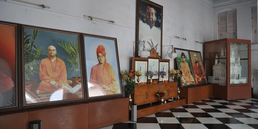 Inside view of a room with a chessboard floor containing pictures of Swami Vivekananda