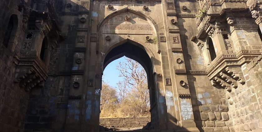 A large, elegant fort with tall towers and intricate architecture under a clear blue sky