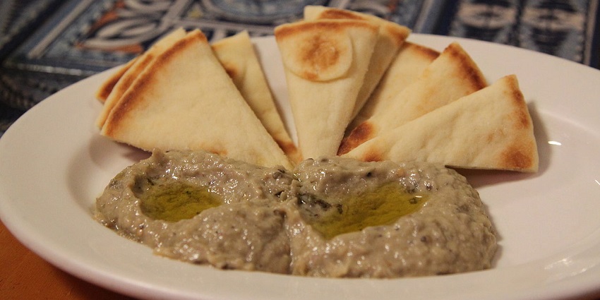 Baba Ganoush and Pita bread, a Lebanese dish topped with herb oil served on a plate, one of the best food in Nashik.