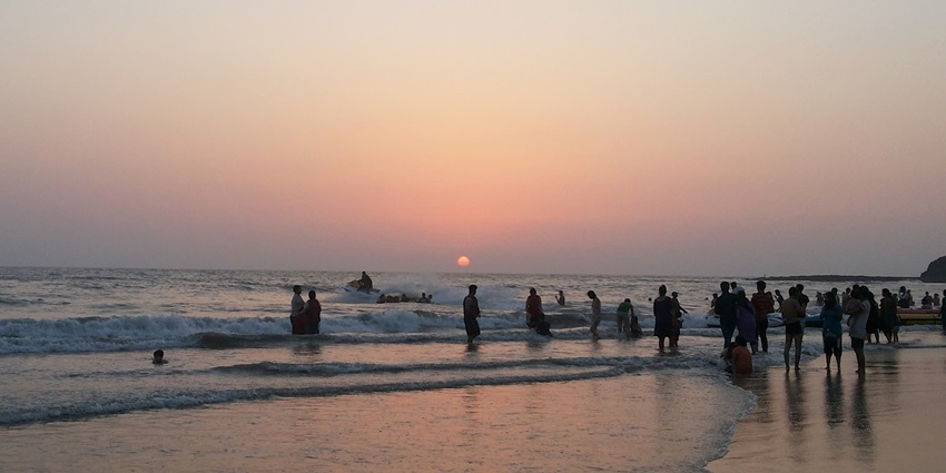 A picture of the most serene sunset at Alibaug beach with calm waters and quiet shores.