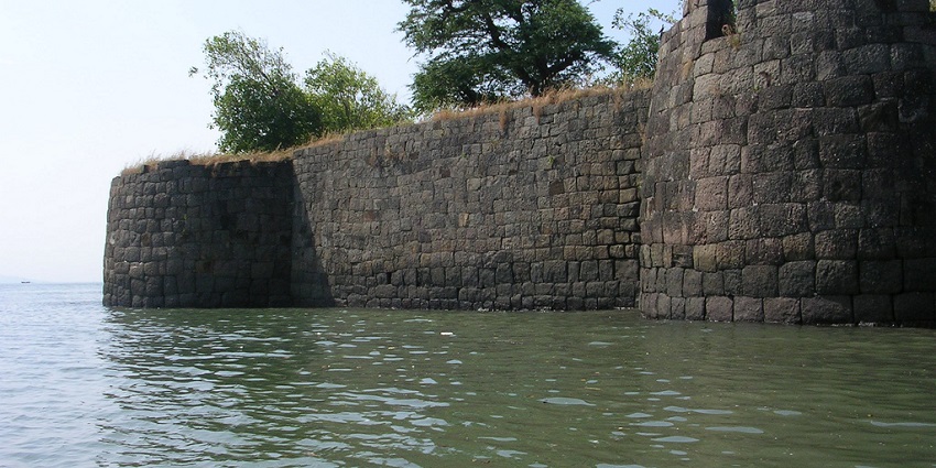 A partially submerged wall of the Kolaba Fort in the coastal town of Alibaug