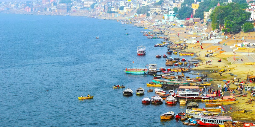 View of the lively Ambe Ghat, with boats lined on the shores