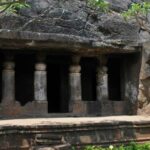 Interior view of Ambivali Caves showcasing intricate carvings and stone formations