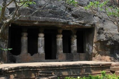 Interior view of Ambivali Caves showcasing intricate carvings and stone formations