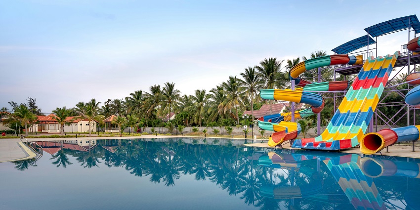 Experience thrilling slides and joyful splashes with family at Ammu Water Park and Resort.