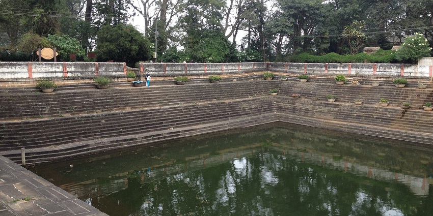 A view of rustic staircase and shimmering blue waters at the Amruth Sarovara, Karnataka.