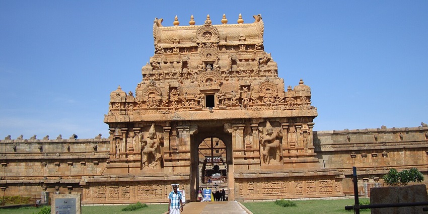 View of the Anaikadavu Nageswarar temple entrance with green lawns on both sides.