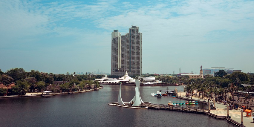 A scenic view of Ancol featuring majestic buildings, shimmering waters, and more.