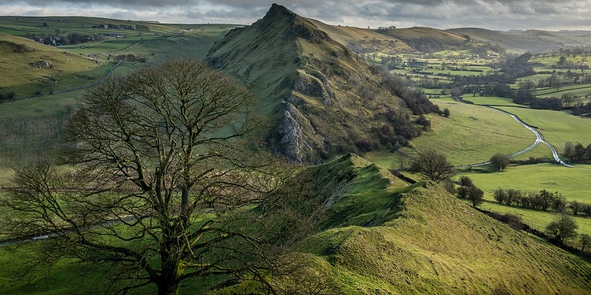 A stunning view of rolling green hills under a bright blue sky, showcasing the beauty of nature.