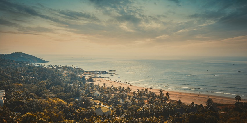 A breathtaking view of Anjuna Beach featuring golden shores and shimmering waters.