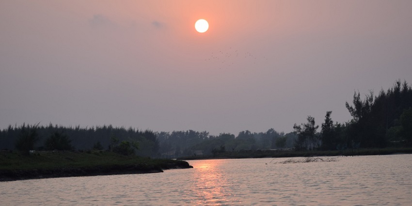 Evening at Anshupa Lake near Bhubaneshwar surrounded by green land and calm water near Atri hot spring