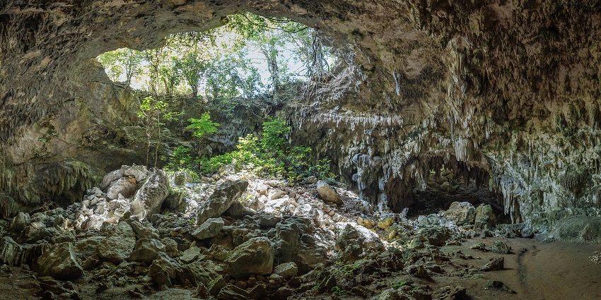 An inside view of a cave with rustic terrains, a famous tourist attraction in Karnataka.
